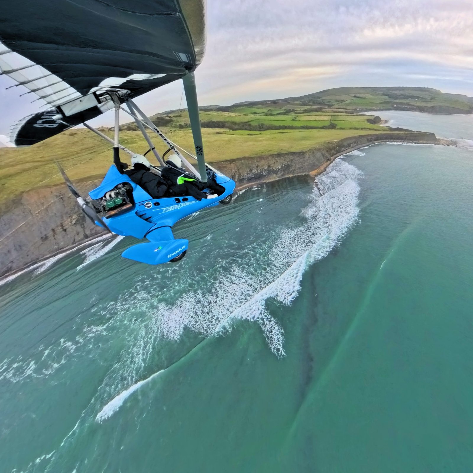 A DeltaJet 500 Stingray microlight flying over the Jurassic Coast in the UK